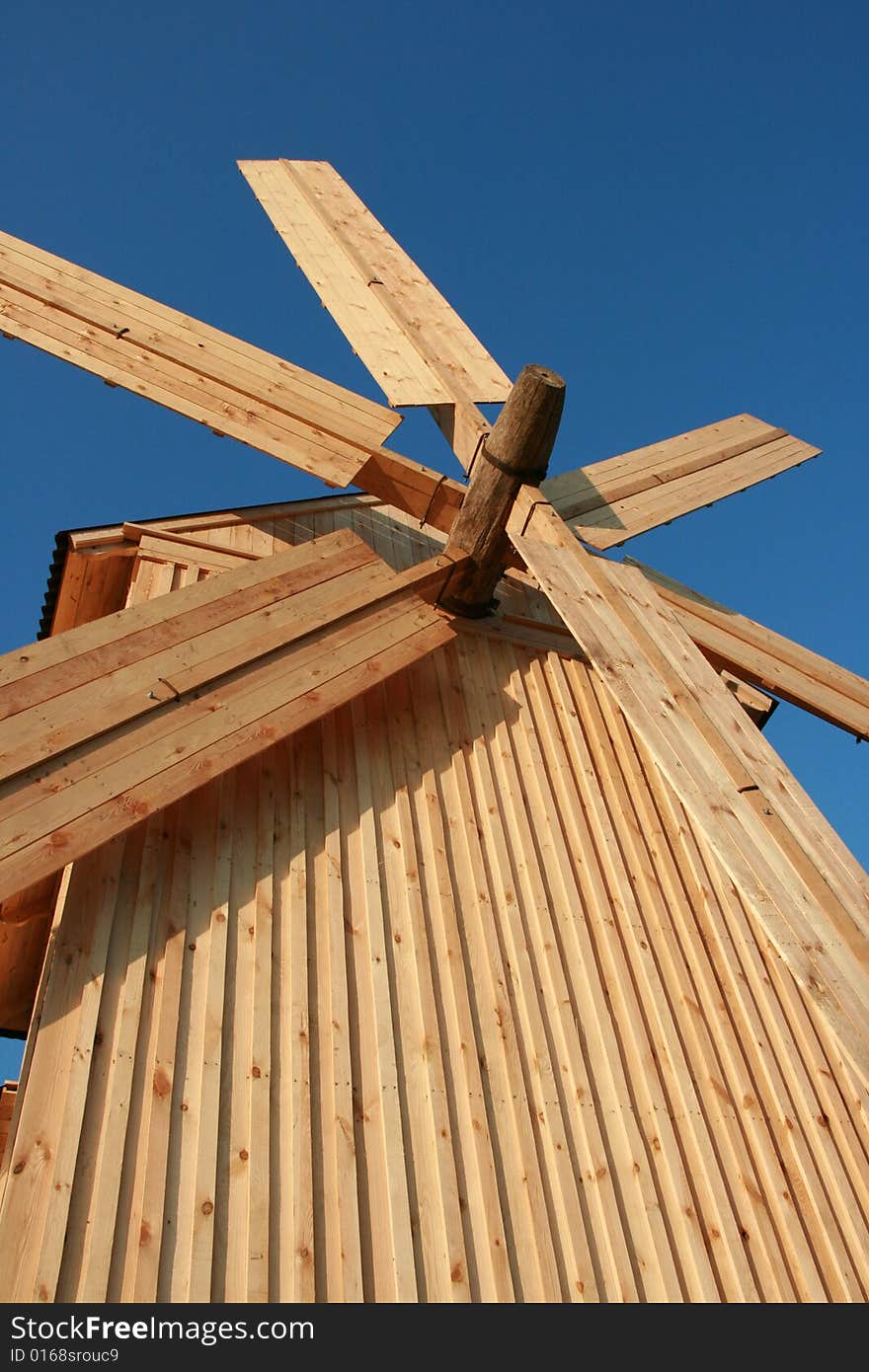 Wooden windmill against clear deep blue sky 2