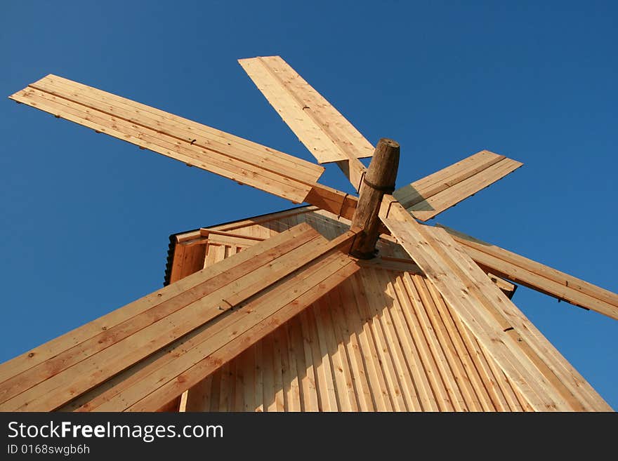 Wooden windmill against clear deep blue sky 3