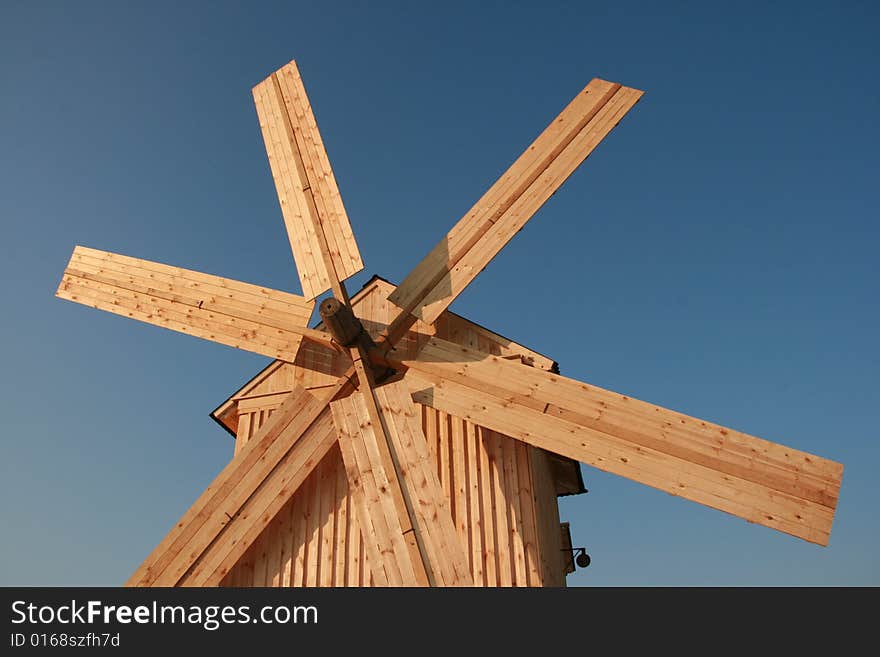 Rural wooden windmill against clear deep blue sky. Rural wooden windmill against clear deep blue sky