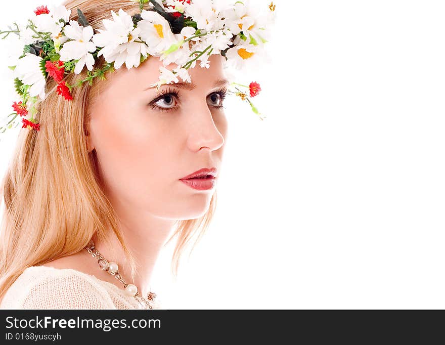 Pretty spring girl with wreath on head looking forward on white background