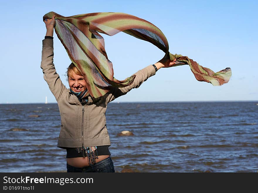 Blond woman with scarf. Windy day.