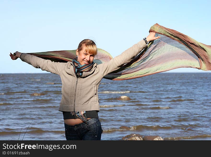 Blond woman with scarf. Windy day.