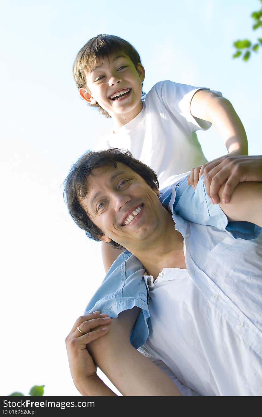 Portrait of young happy father getting busy with his son. Portrait of young happy father getting busy with his son