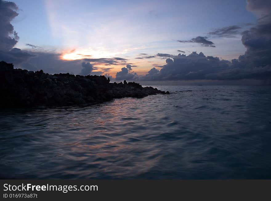 Water, clouds and rocks at sunrise. Water, clouds and rocks at sunrise