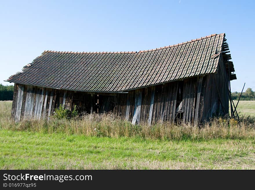 Old abandoned barn in a field
