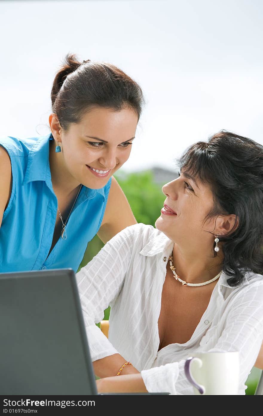 Portrait of  two women  getting busy with  laptop. Portrait of  two women  getting busy with  laptop