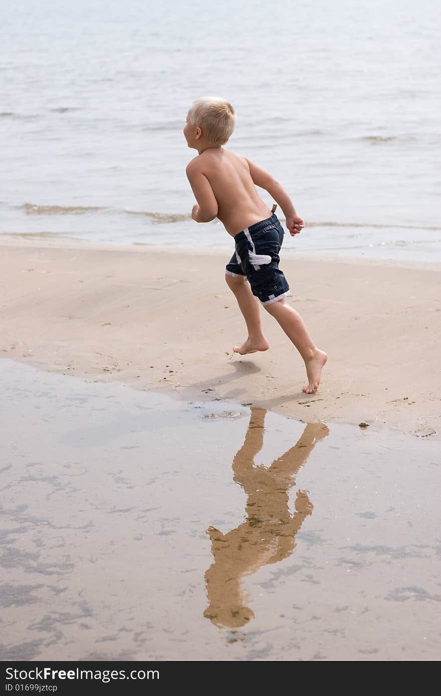 Boy running along the beach