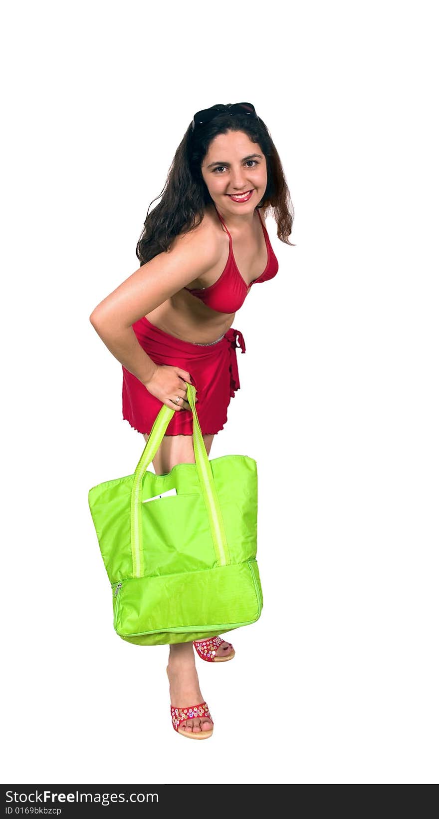 Pretty brunette girl in swim suit with beach bag