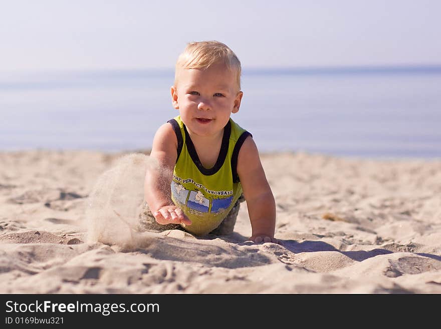 Boy digging sand in the summer. Boy digging sand in the summer