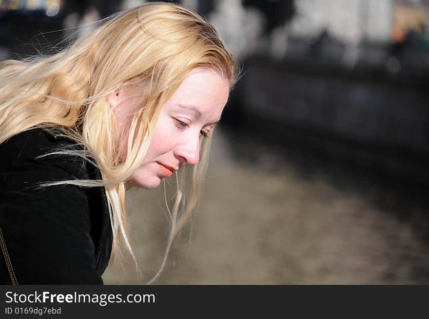 Young woman looking down at water. Young woman looking down at water