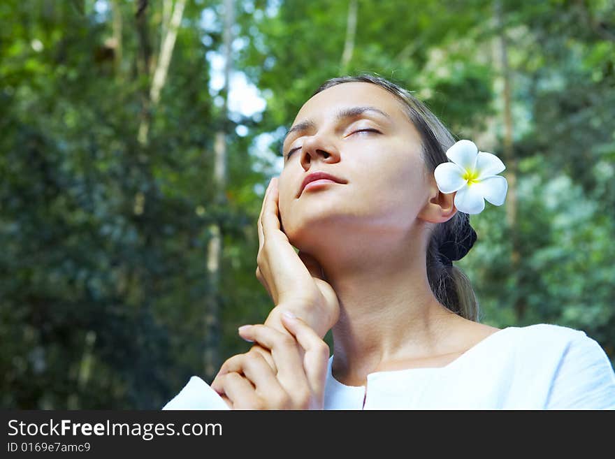 Portrait of fresh and beautiful human with flower in summer environment. Portrait of fresh and beautiful human with flower in summer environment