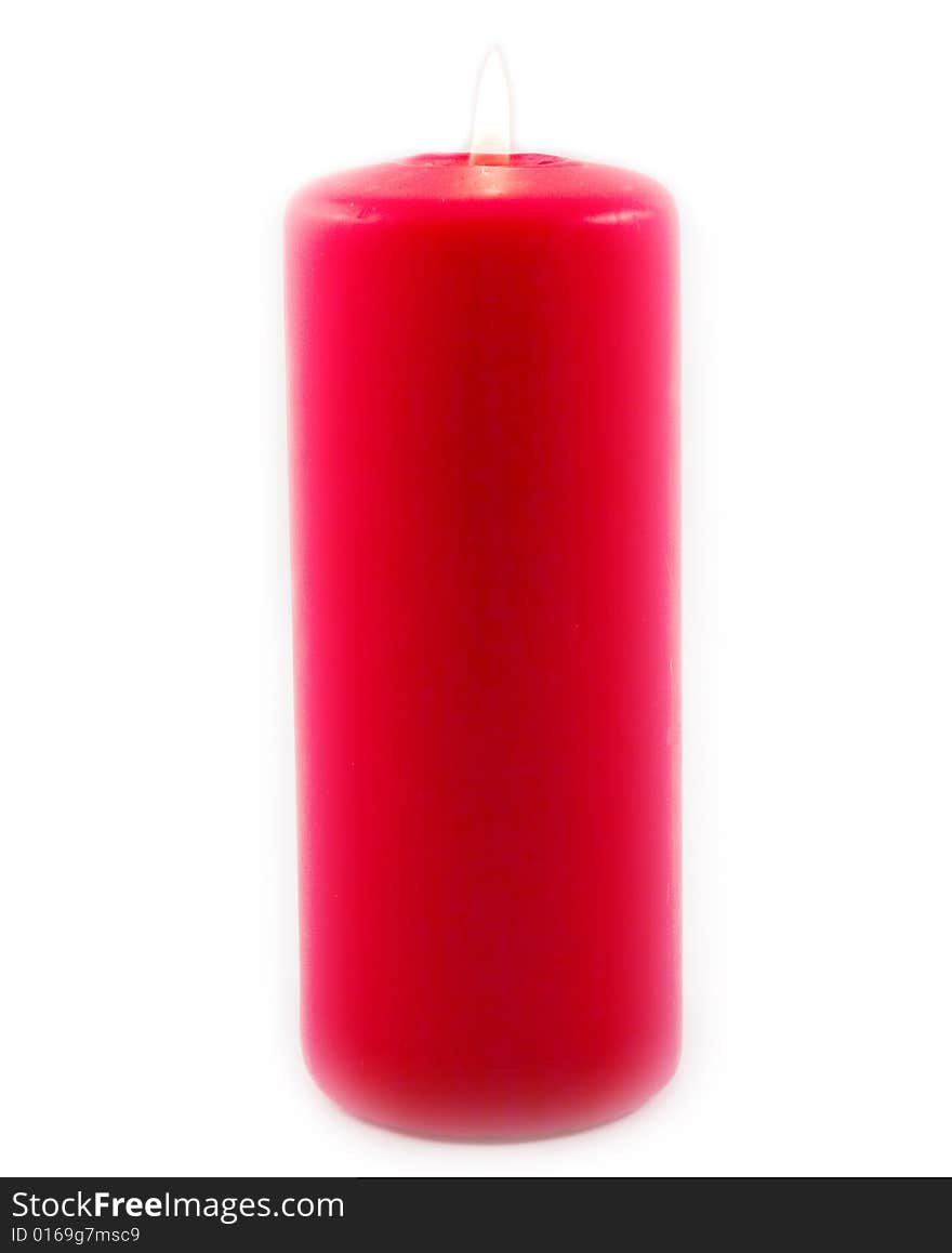 Red celebratory burning candle made of paraffin on white background