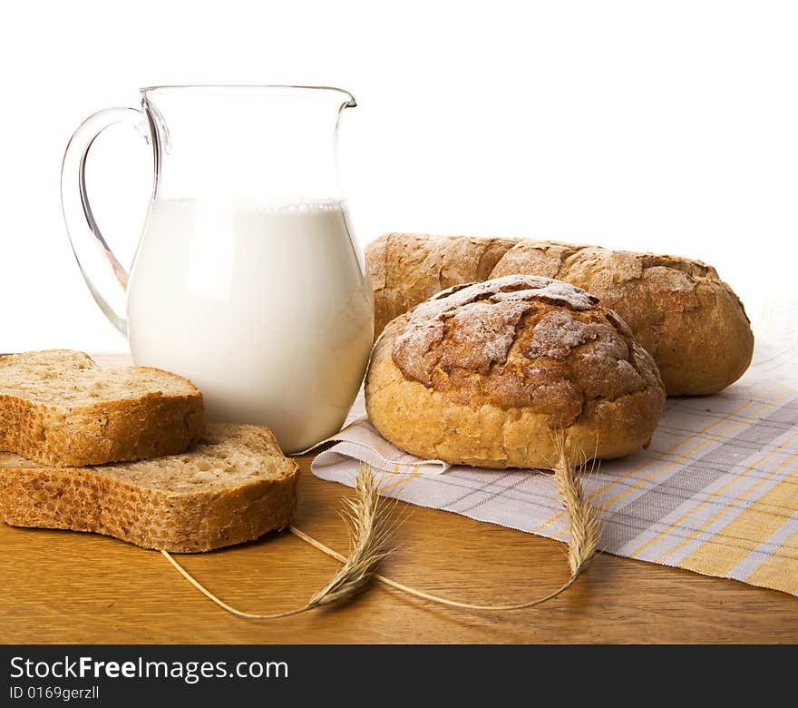 Jug with milk, bread and wheat. Jug with milk, bread and wheat