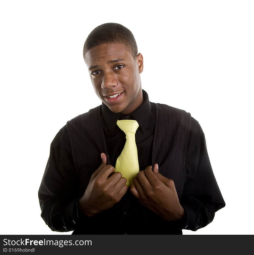 A young black man with a yellow tie and black vest. A young black man with a yellow tie and black vest