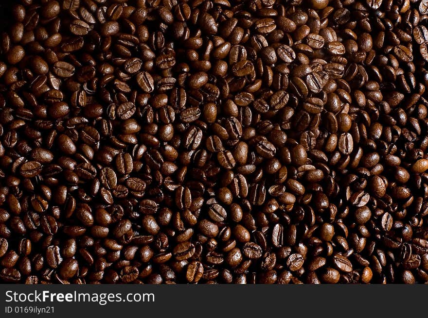 Roasted coffee beans heap macro shot. Roasted coffee beans heap macro shot