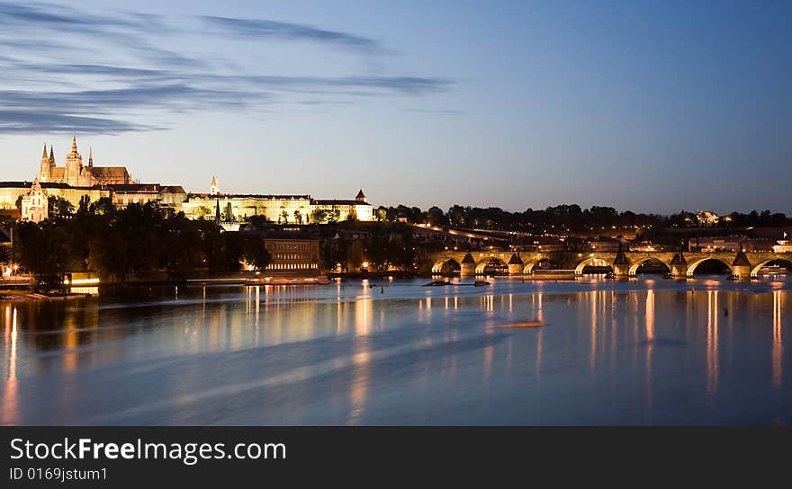 Sunset panorama of Prague castle and Charles Bridge with reflection in Vltava river. Sunset panorama of Prague castle and Charles Bridge with reflection in Vltava river.