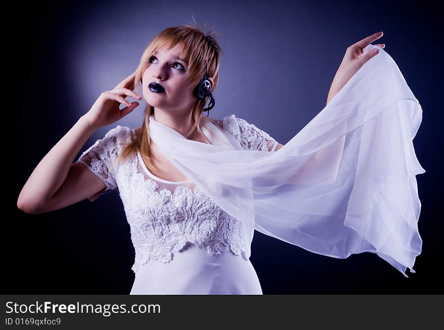 Romantic girl listening to the music, isolated in studio