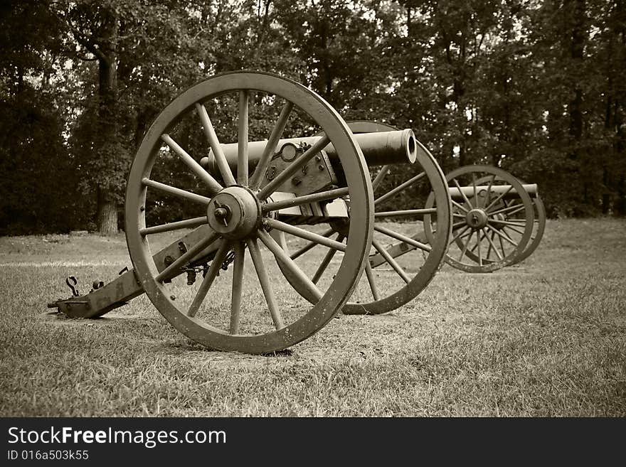 A vintage sepia photograph of old Civil War era canons. A vintage sepia photograph of old Civil War era canons