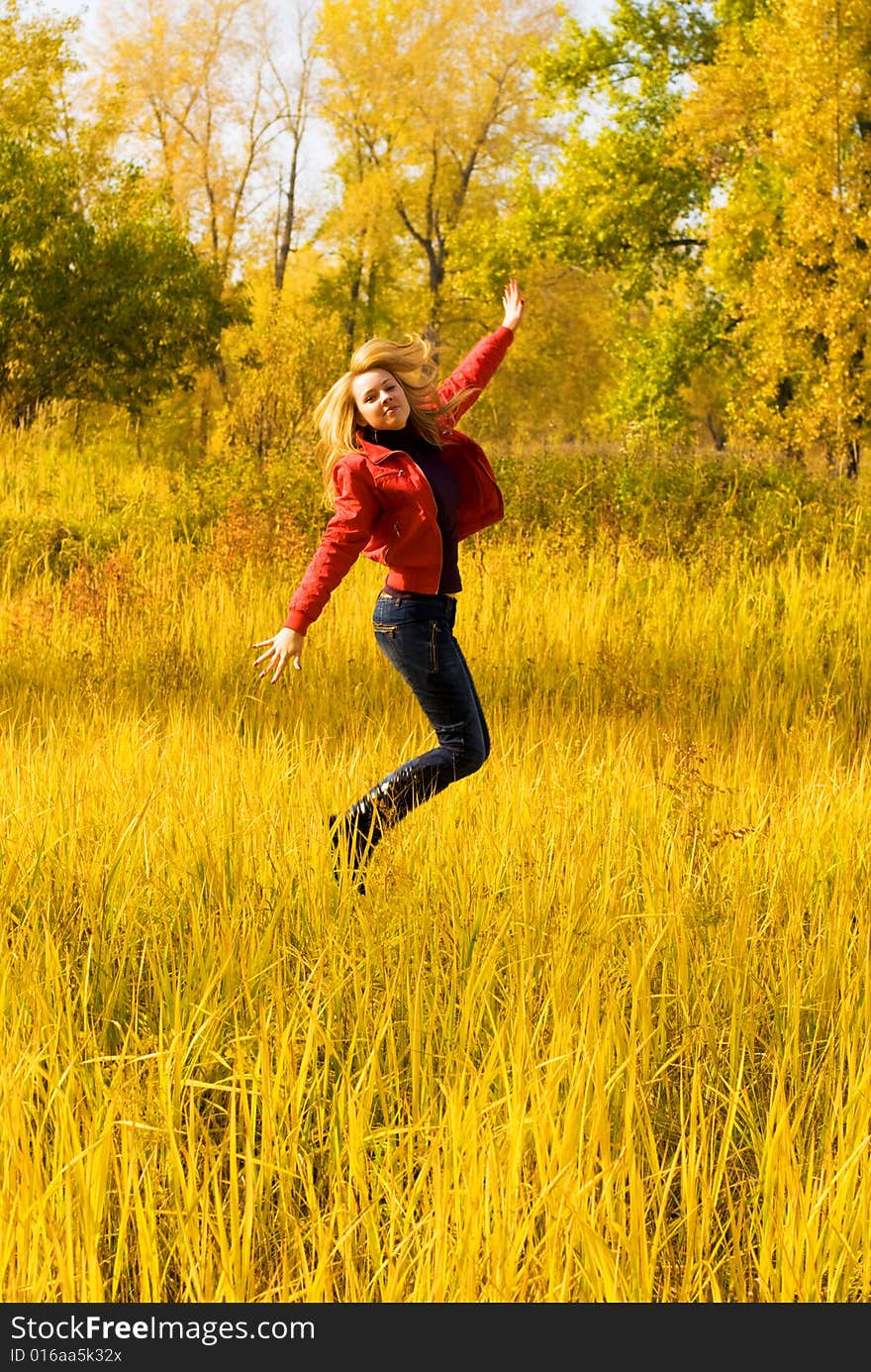 Happy girl jumping in the park