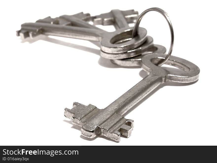 Bounch of keys from steel on a white background. Bounch of keys from steel on a white background