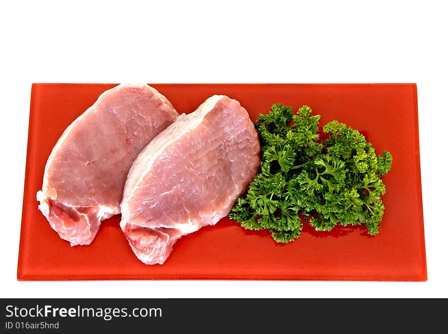 Tenderloin steak on red plate, white background, studio shot,. Tenderloin steak on red plate, white background, studio shot,