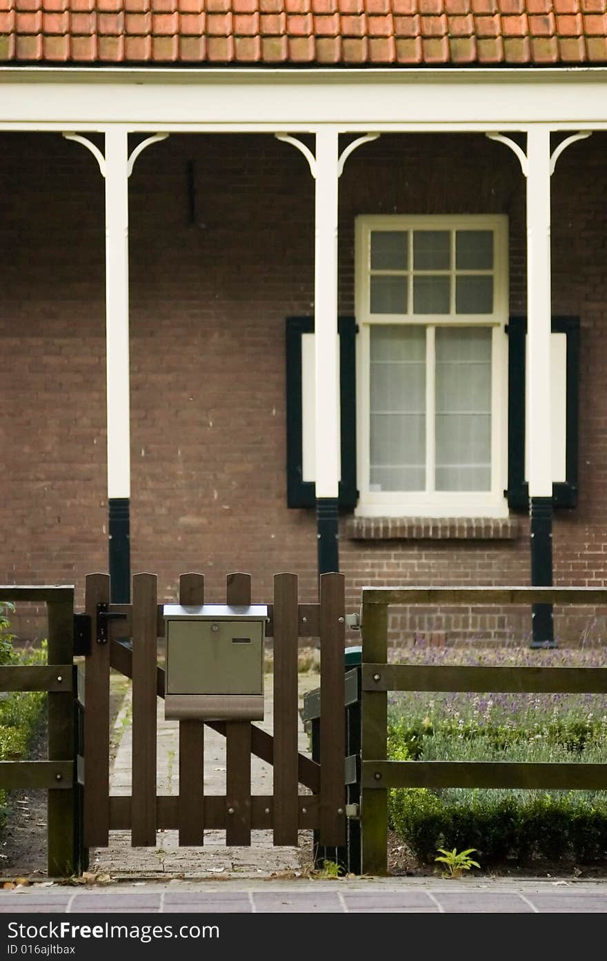 Entrance gate of a coountryside house with a wooden fence