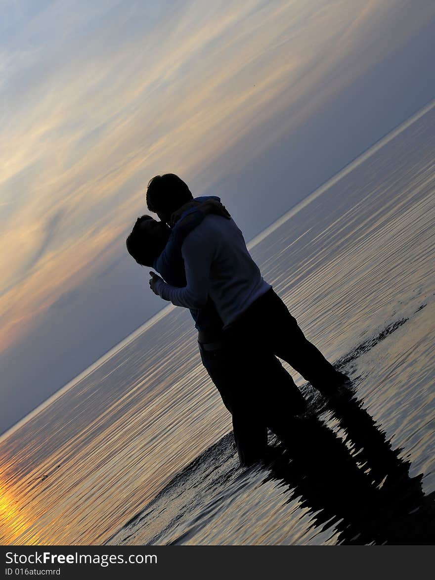 Two silhouettes of in love pair on a background sunset. Two silhouettes of in love pair on a background sunset