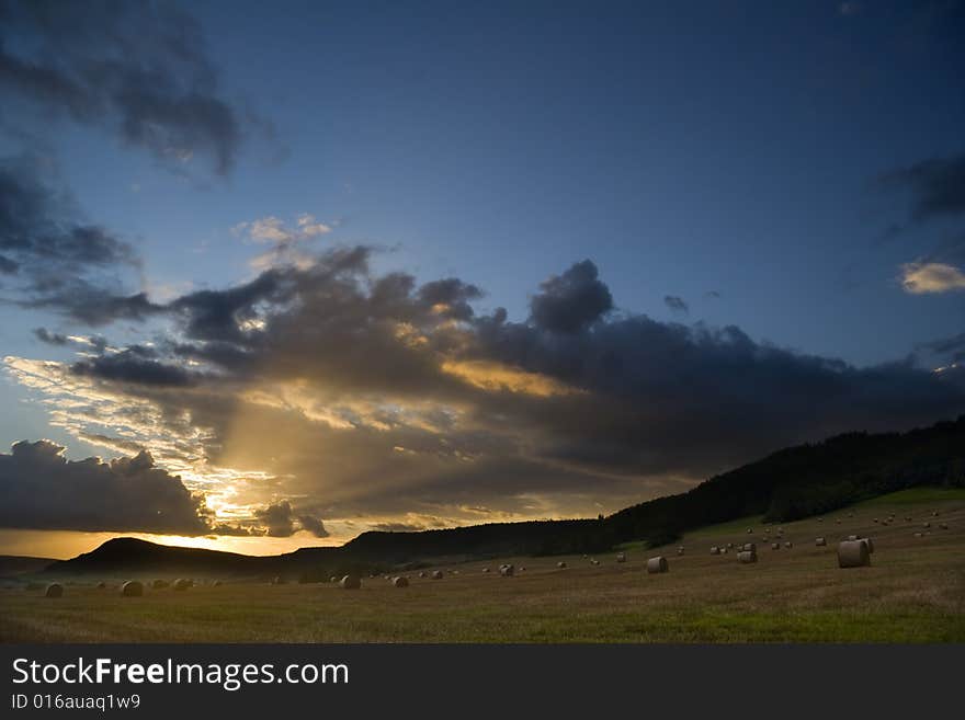 Thundery clouds over field at evening