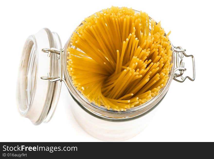 Pasta in glass can on a white background