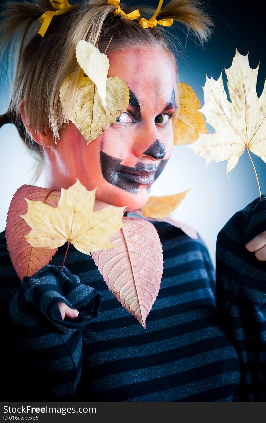 Jack-o-lantern girl with leaves isolated in studio