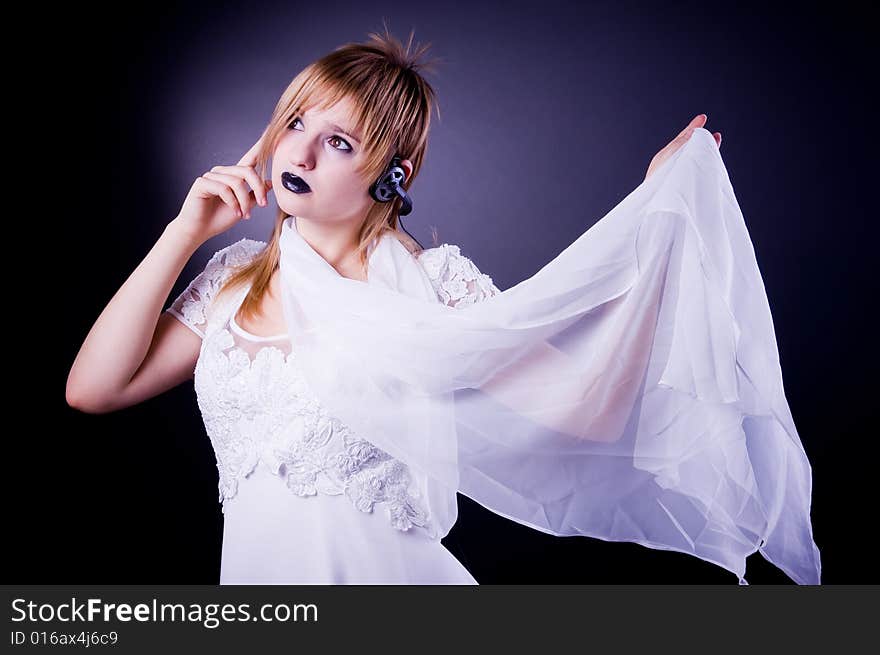 Romantic girl listening in headphones, isolated in studio