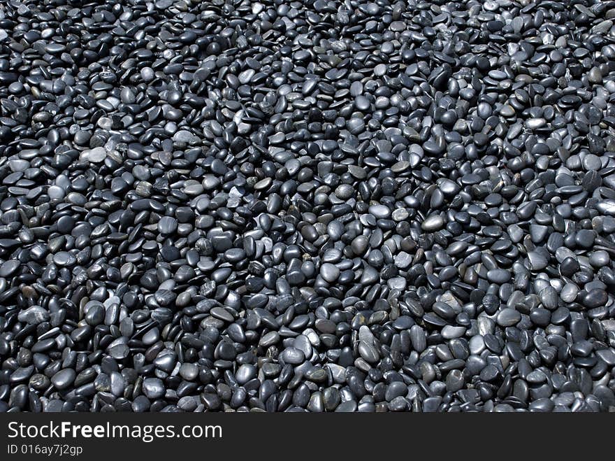 Thousands of dark grey pebbles. Thousands of dark grey pebbles