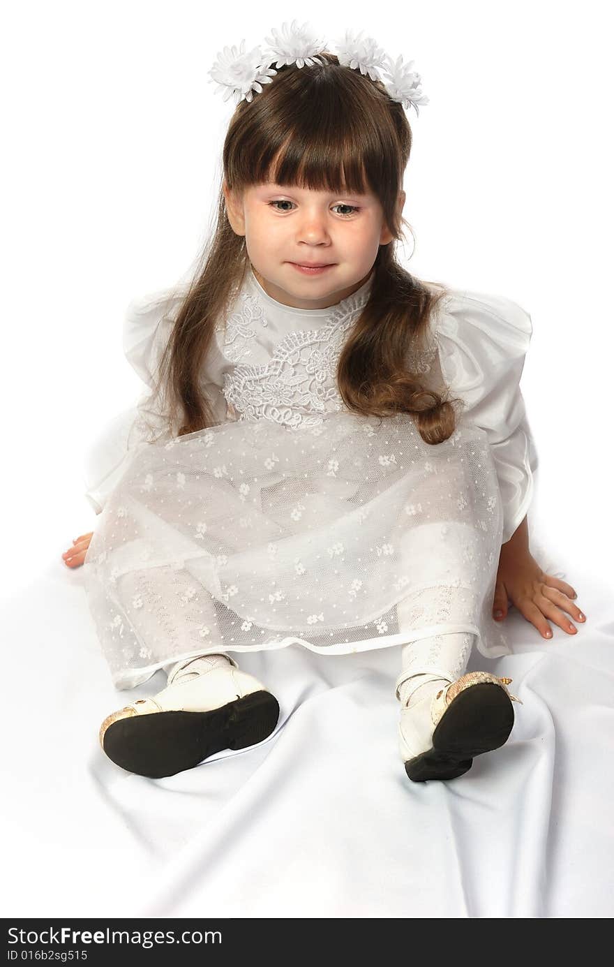 The girl in a white dress. It is isolated on a white background. Age 3 years