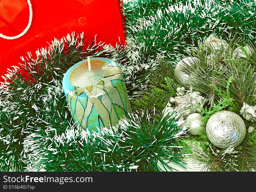 Decorative candle over green new year adorning. Decorative candle over green new year adorning