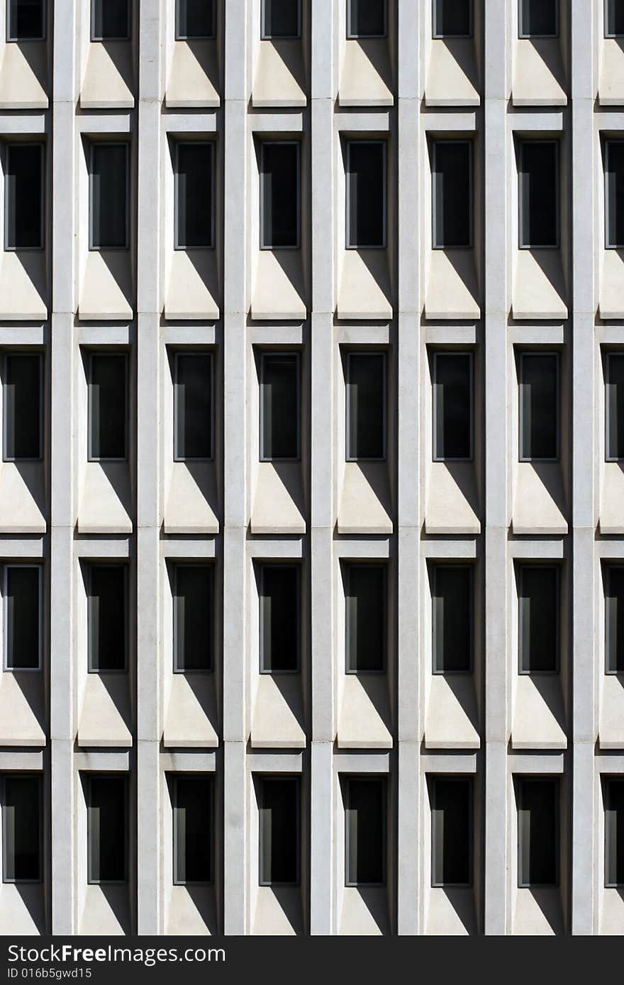 Shaded glass windows of modern office building in downtown Phoenix, Arizona. Because of the very bright and hot Arizona sunshine, modern buildings use windows recessed into the building for shade. Shaded glass windows of modern office building in downtown Phoenix, Arizona. Because of the very bright and hot Arizona sunshine, modern buildings use windows recessed into the building for shade.