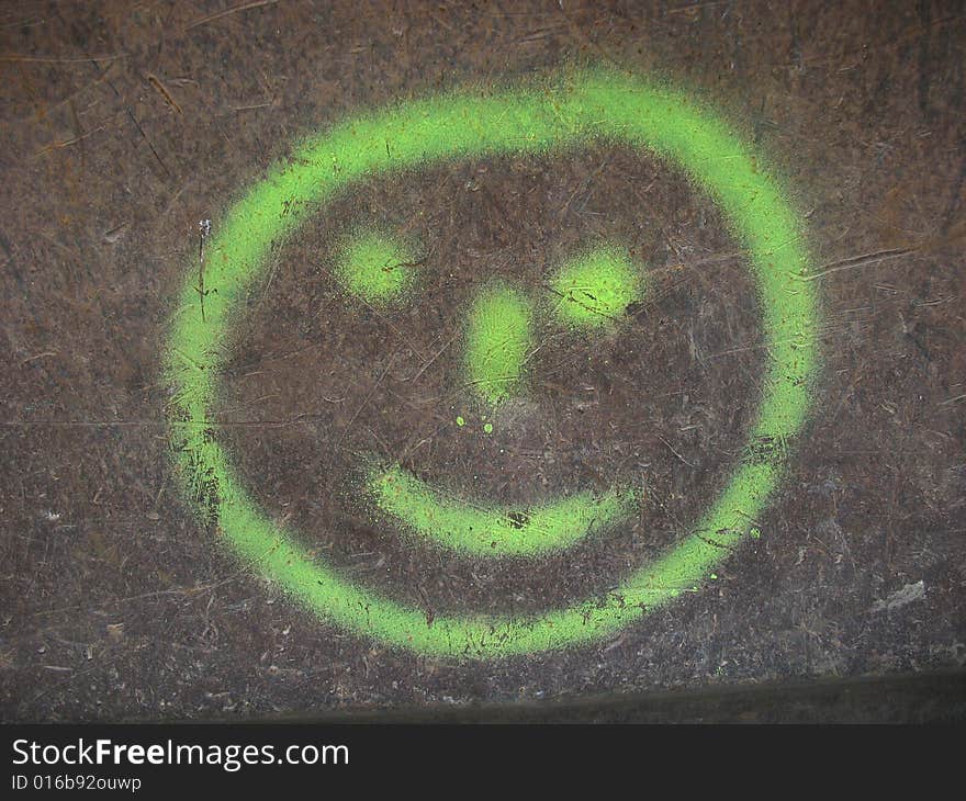 Graffity smiley on rusty underground. Graffity smiley on rusty underground