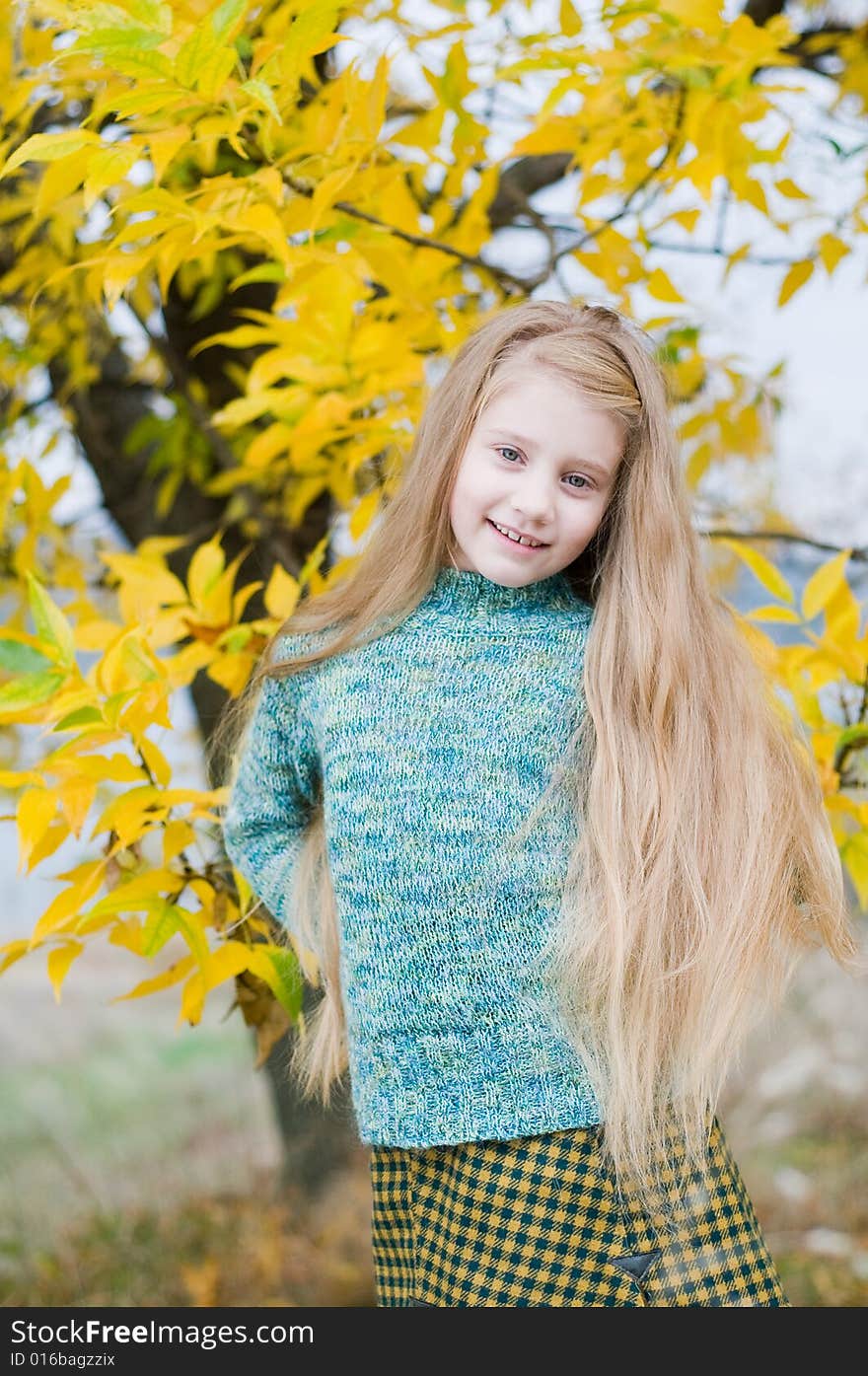 Little girl over yellow tree background. Little girl over yellow tree background