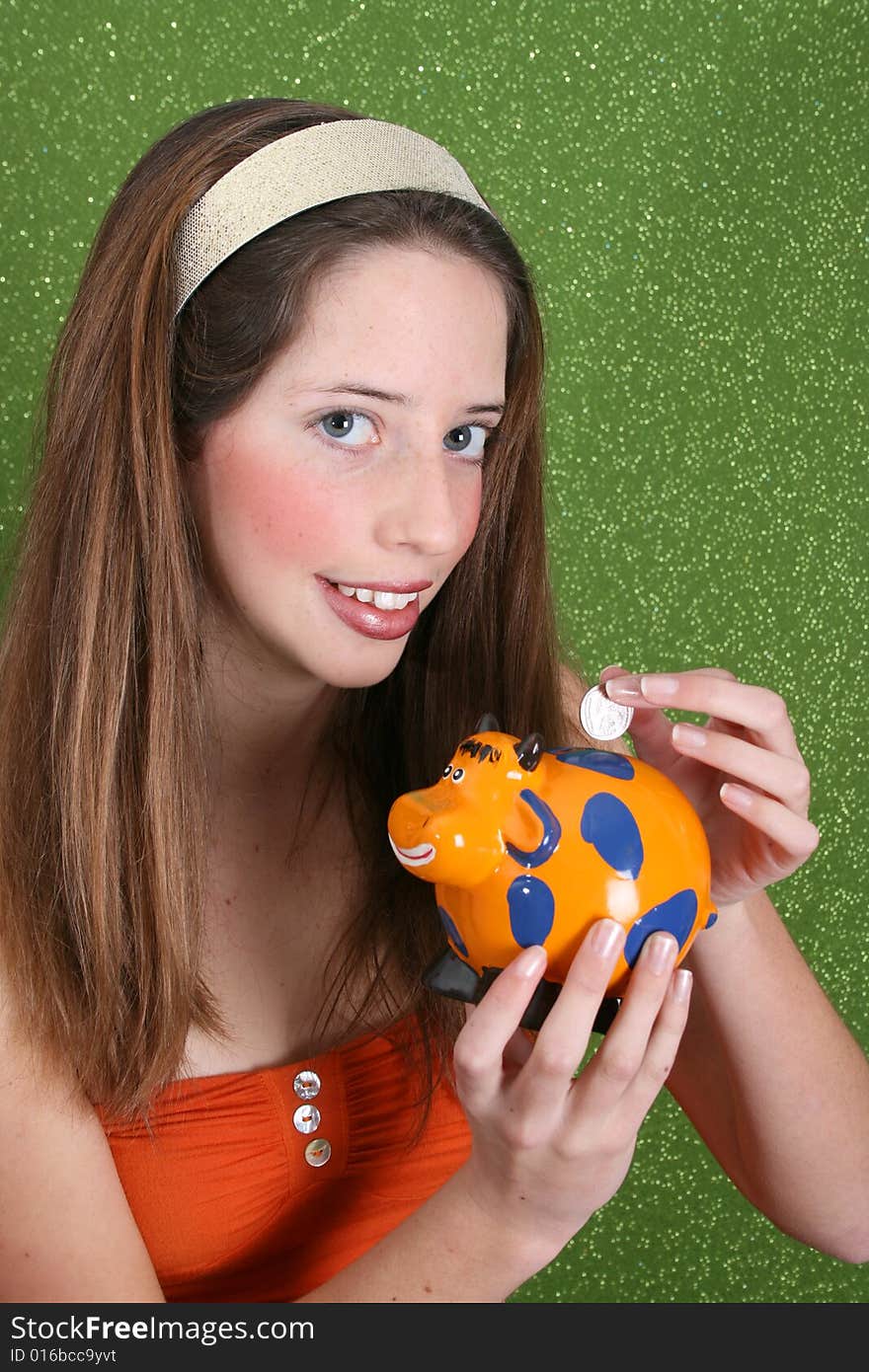 Brunette teenager on a green background wearing a broad head band. Brunette teenager on a green background wearing a broad head band