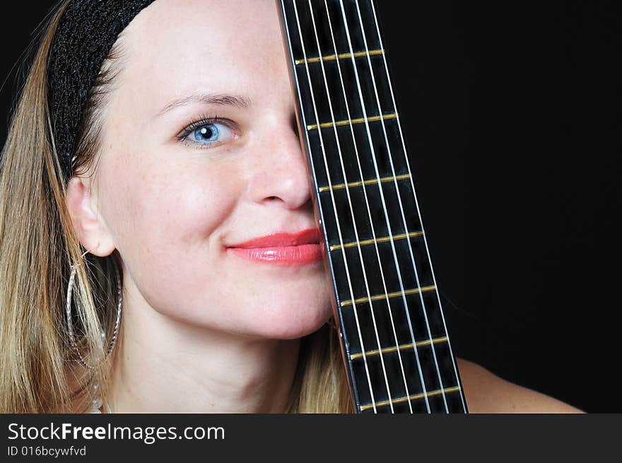 Portrait of the nice woman behind fretboard