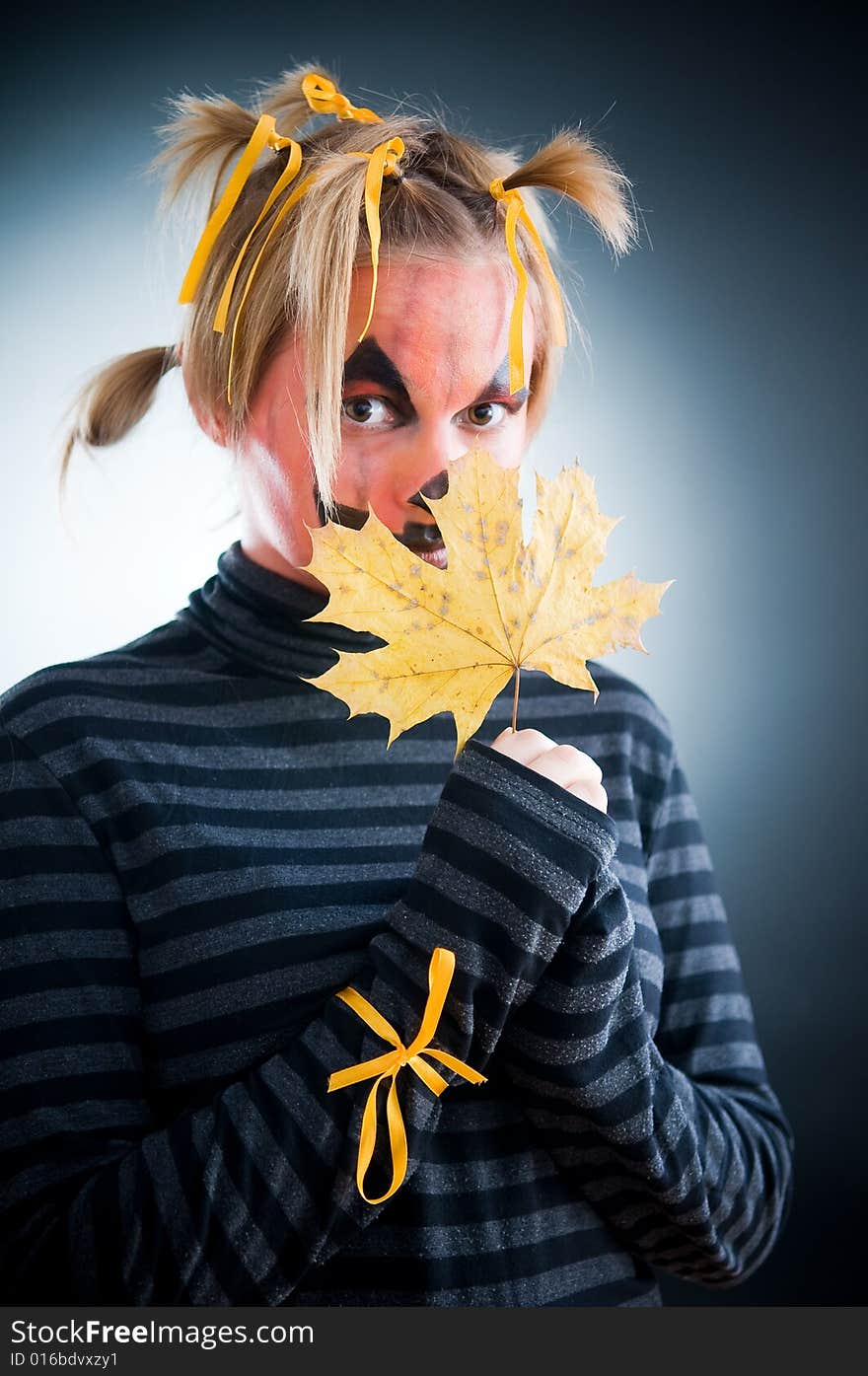 Halloween girl with leaves isolated in studio