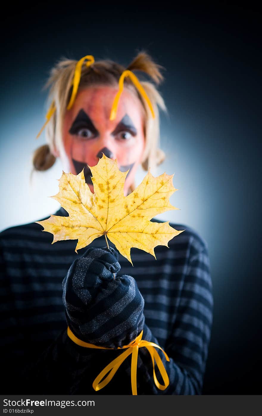 Halloween girl with tied hands, focus on leaf