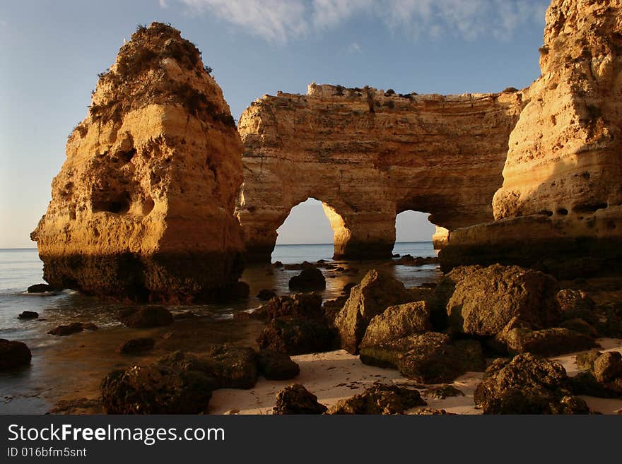 A natural formation (double arch) at the coast (Portugal) with light of sunrise. A natural formation (double arch) at the coast (Portugal) with light of sunrise.