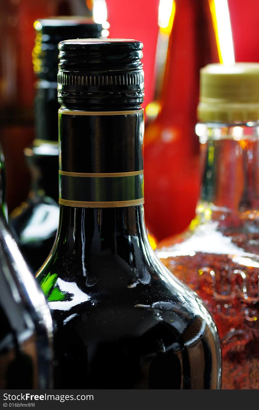 Bottles on the red background. Narrow depth of field. Bottles on the red background. Narrow depth of field.