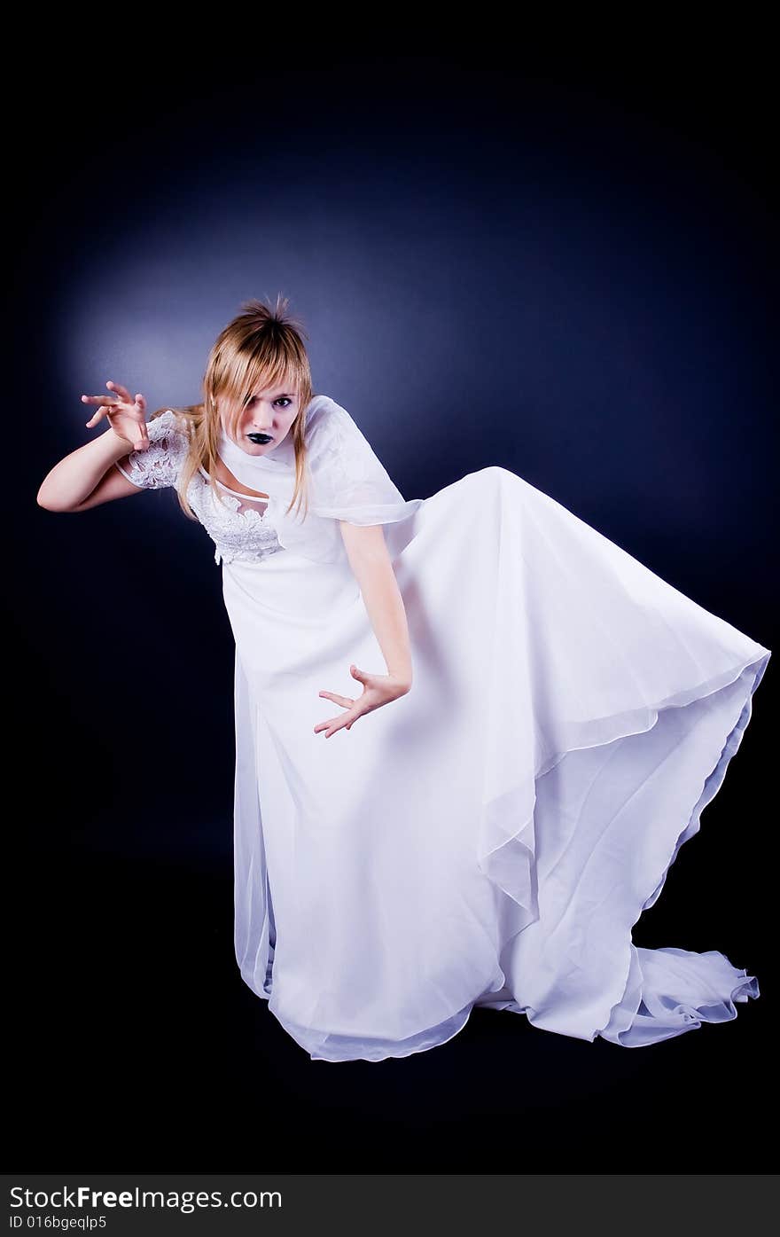 Expressive girl in wedding dress, studio isolated