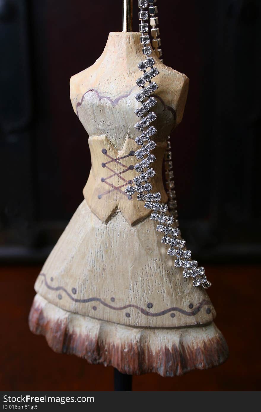 Wooden Jewelery stand with diamond necklace hanging