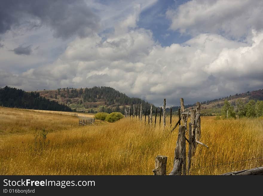 Farm in the mountains with a rain storm. Farm in the mountains with a rain storm