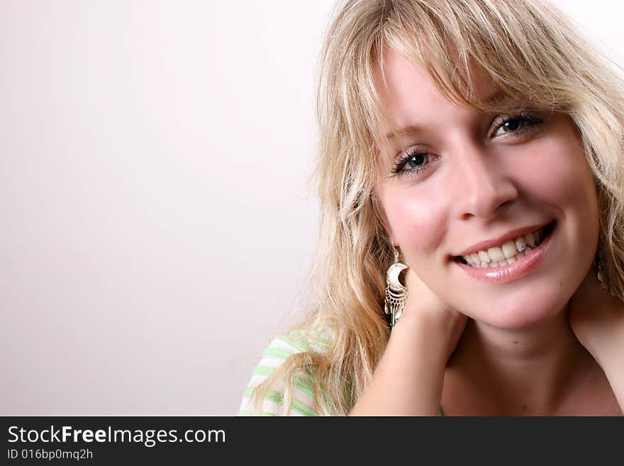 Blond Female model on a white background wearing a green top. Blond Female model on a white background wearing a green top