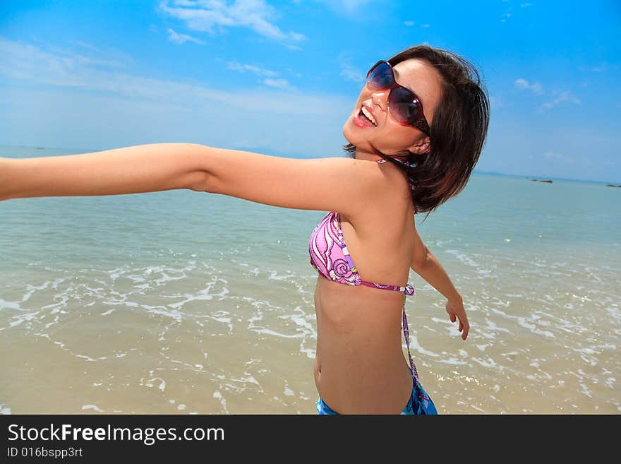 Asian young woman having fun at the beach