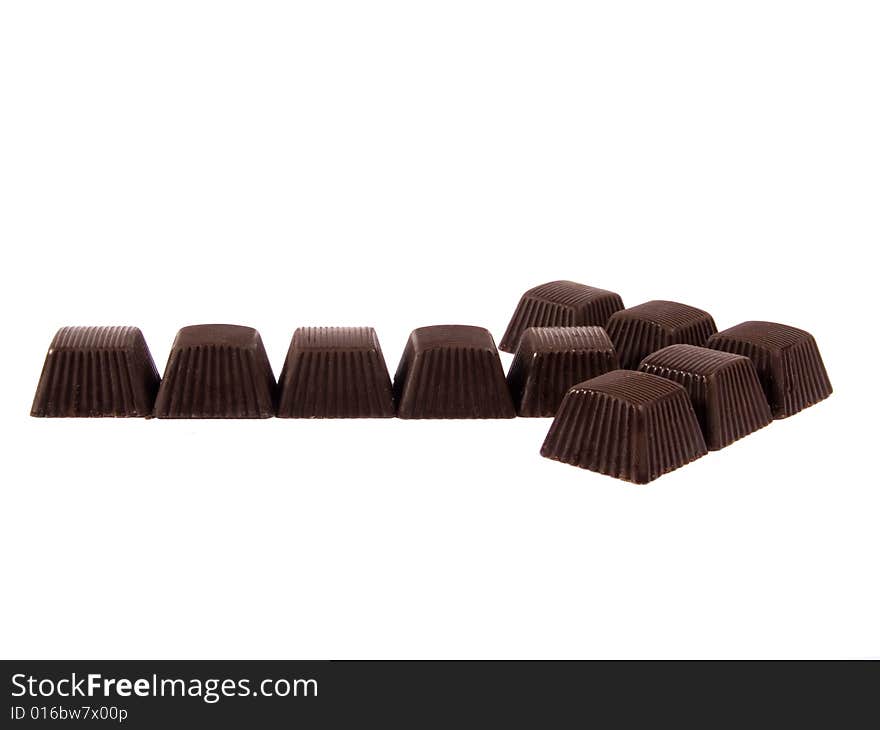 Chocolates composed in arrow on a white background. Chocolates composed in arrow on a white background