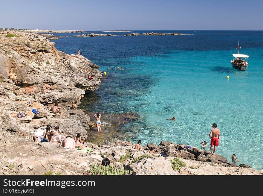 People at cliff shore swimming